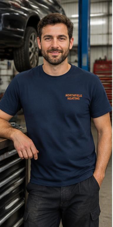 Man wearing a navy printed work T-shirt in a garage workshop